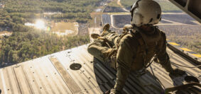 U.S. Marine Corps Cpl. Michael A. Culbertson, crew chief, Marine Aircraft Group 29, 2nd Marine Aircraft Wing, observes the terrain during the flight back to Marine Corps Air Station (MCAS) New River after participating in a mishap training at Wilmington International Airport in Wrightsboro, North Carolina, Dec. 14, 2023. Marines with MCAS New River and Marine Operational Test and Evaluation Squadron 1 integrated with civilian first responders from New Hanover County to conduct a military aircraft mishap training to enhance emergency response skills between civilian and military first responders. (U.S. Marine Corps photo by Lance Cpl. Alyssa J. Deputee)