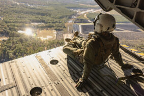 U.S. Marine Corps Cpl. Michael A. Culbertson, crew chief, Marine Aircraft Group 29, 2nd Marine Aircraft Wing, observes the terrain during the flight back to Marine Corps Air Station (MCAS) New River after participating in a mishap training at Wilmington International Airport in Wrightsboro, North Carolina, Dec. 14, 2023. Marines with MCAS New River and Marine Operational Test and Evaluation Squadron 1 integrated with civilian first responders from New Hanover County to conduct a military aircraft mishap training to enhance emergency response skills between civilian and military first responders. (U.S. Marine Corps photo by Lance Cpl. Alyssa J. Deputee)
